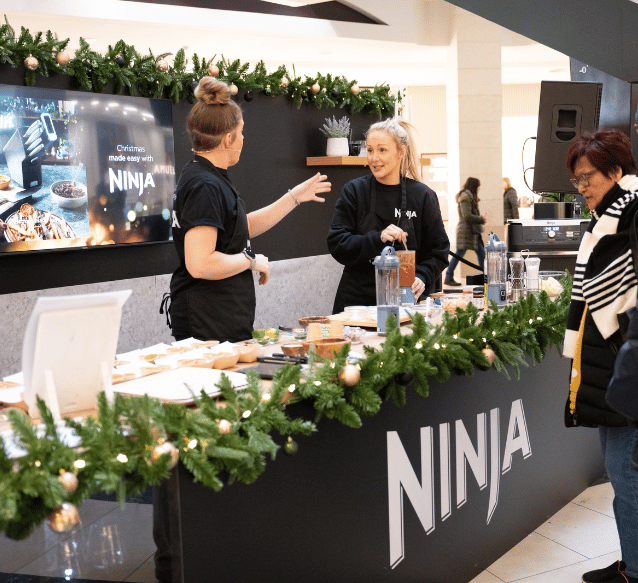 Two women working at the Ninja stand