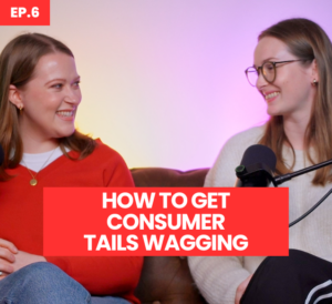 Two women are sat on a sofa looking at each other laughing. The woman sat on the left is wearing a red cardigan, the woman on the right is wearing glasses and a white top with 'ep 6' in the top left corner. Writing on screen says 'How to get consumer tails wagging'